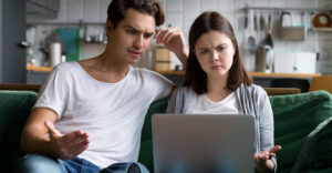 Frustrated couple looking at a laptop screen